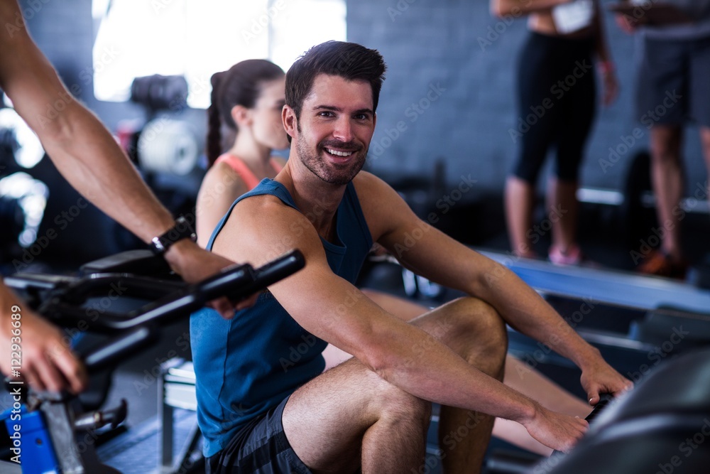 Happy young man exercising in gym Happy young man exercising in gym