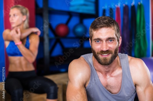 Portrait of cheerful young man in gym