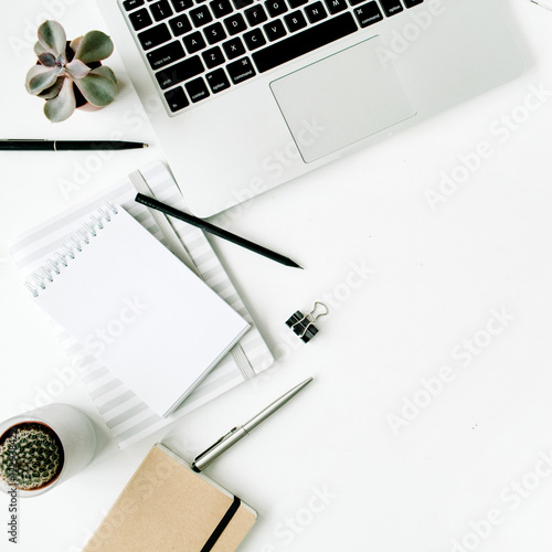 Stylish office table desk. Workspace with laptop, diary, succulent on white background.