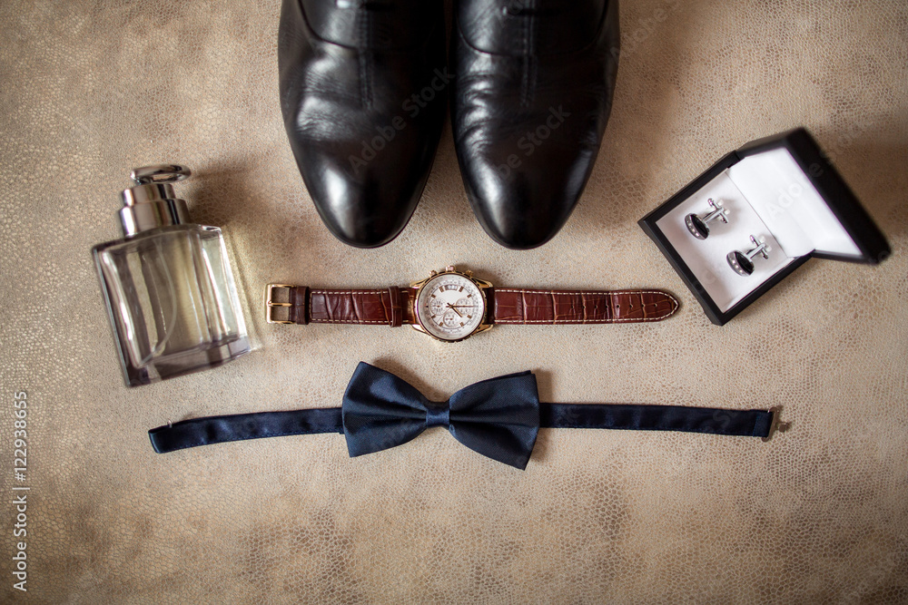 Wedding details. Man accessories. Gromm shoes, hand watch, perfume, bowtie,  and box with cufflinks Stock Photo