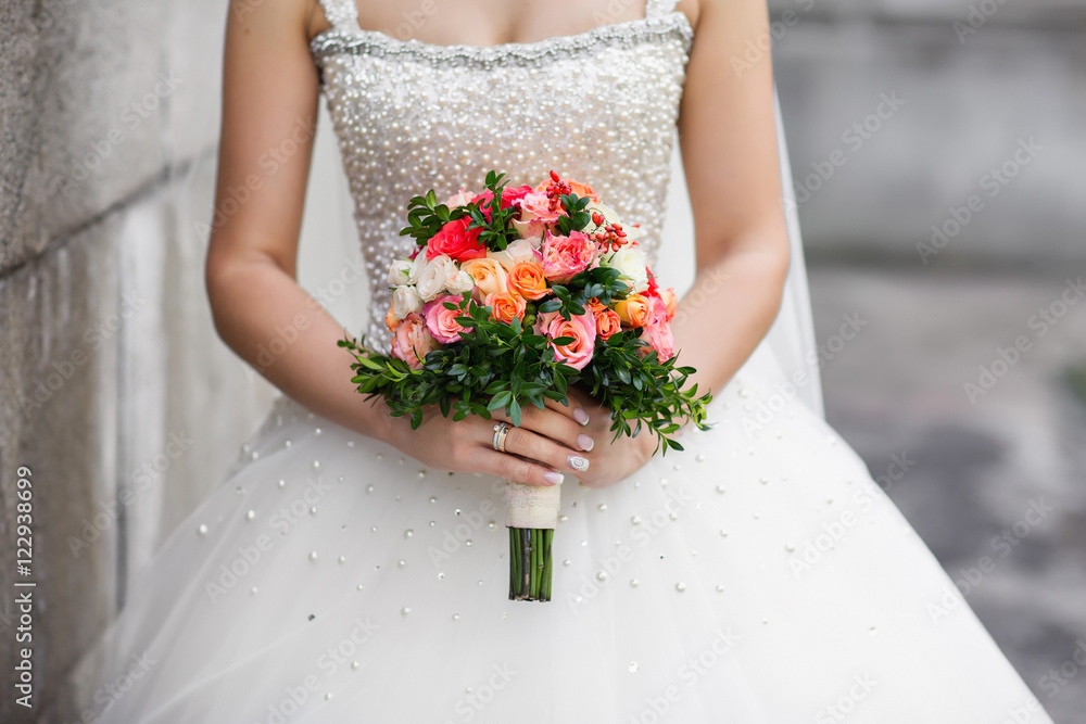Wedding bouquet. Close up beautiful bride's bouquet. Bouquet of flowers on the background of a beautiful wedding dress Wedding bouquet. Close up beautiful bride's bouquet. Bouquet of flowers on the background of a beautiful wedding dress