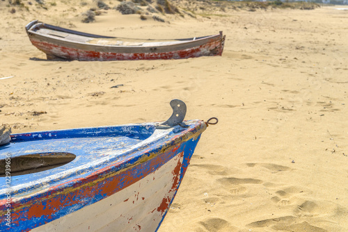 Abandoned fishing boat on one of the most beautiful beaches in t photo