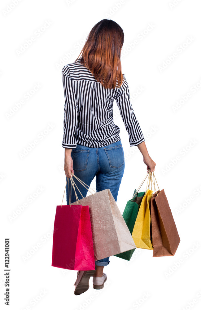 back view of going woman with shopping bags . beautiful girl in motion. backside view of person. Rear view people collection. Isolated over white background. Happy girl is swinging colorful back view of going woman with shopping bags . beautiful girl in motion. backside view of person. Rear view people collection. Isolated over white background. Happy girl is swinging colorful