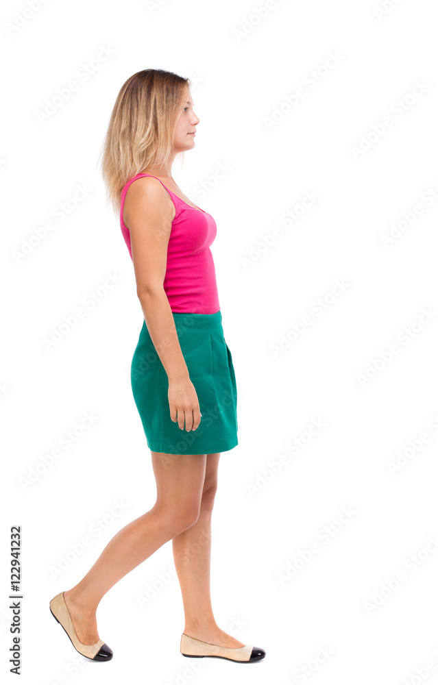 back view of walking woman. beautiful girl in motion. backside view of person. Rear view people collection. Isolated over white background. Girl in a green skirt is in the side. back view of walking woman. beautiful girl in motion. backside view of person. Rear view people collection. Isolated over white background. Girl in a green skirt is in the side.