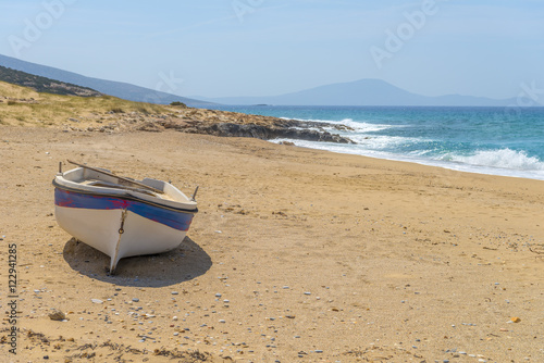Abandoned fishing boat on one of the most beautiful beaches in t photo