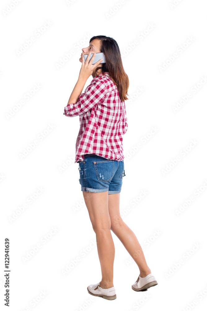 back view of a woman talking on the phone. backside view of person. Rear view people collection. Isolated over white background. Girl in shorts on the phone back view of a woman talking on the phone. backside view of person. Rear view people collection. Isolated over white background. Girl in shorts on the phone