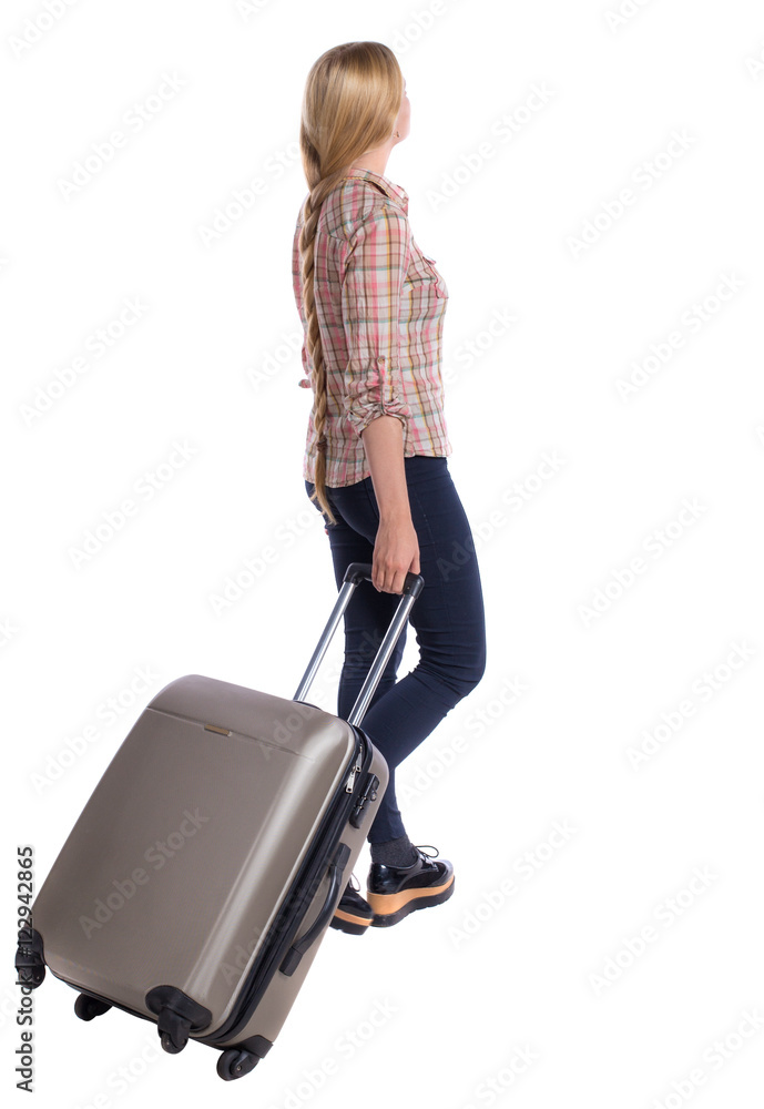 back view of walking woman with suitcase. beautiful girl in motion. backside view of person. Rear view people collection. Isolated over white background. Girl with very long hair is on the side back view of walking woman with suitcase. beautiful girl in motion. backside view of person. Rear view people collection. Isolated over white background. Girl with very long hair is on the side