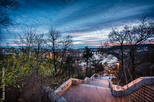 stairs leading to river Vltava in Prague in winter at sunset