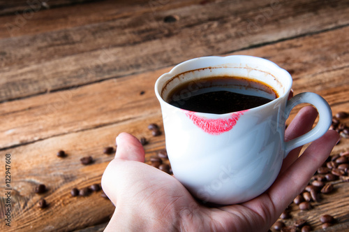 Red lipstick on a cup of coffee. Copyspace