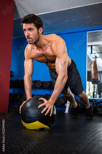 Determined athlete exercising in gym