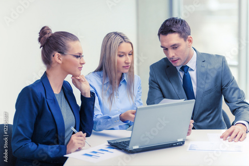 business team with laptop having discussion
