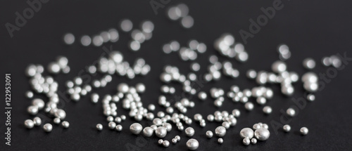 Pure silver granules on a dark background