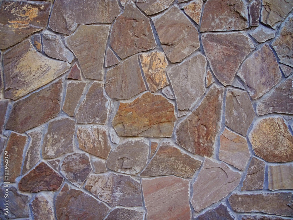 Fototapeta premium pattern color decorative uneven cracked real stone wall