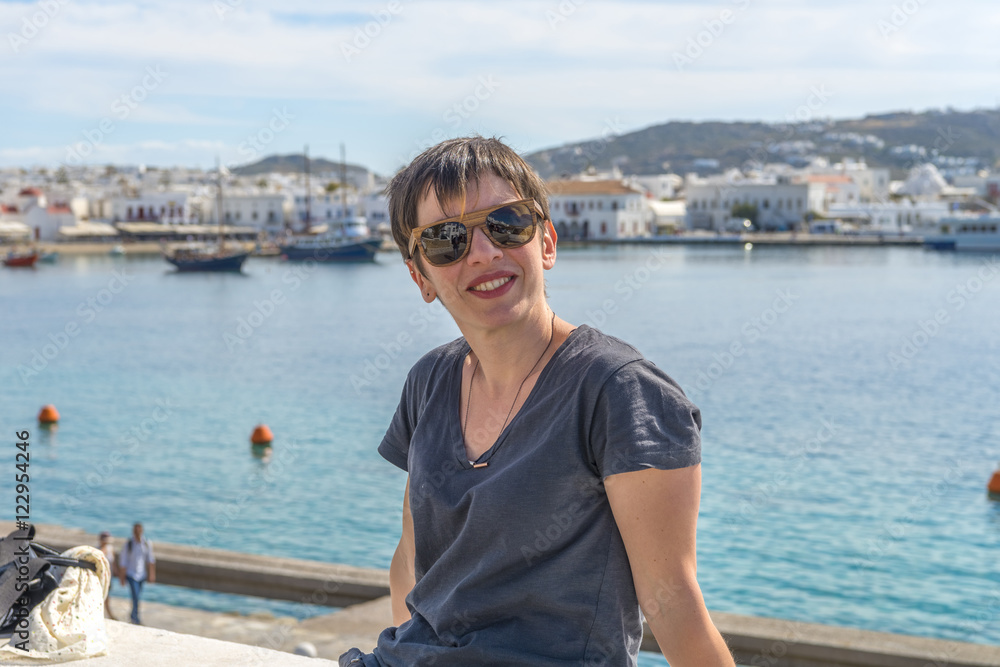 Young beautiful woman enjoying the view at Mykonos port, Cyclade