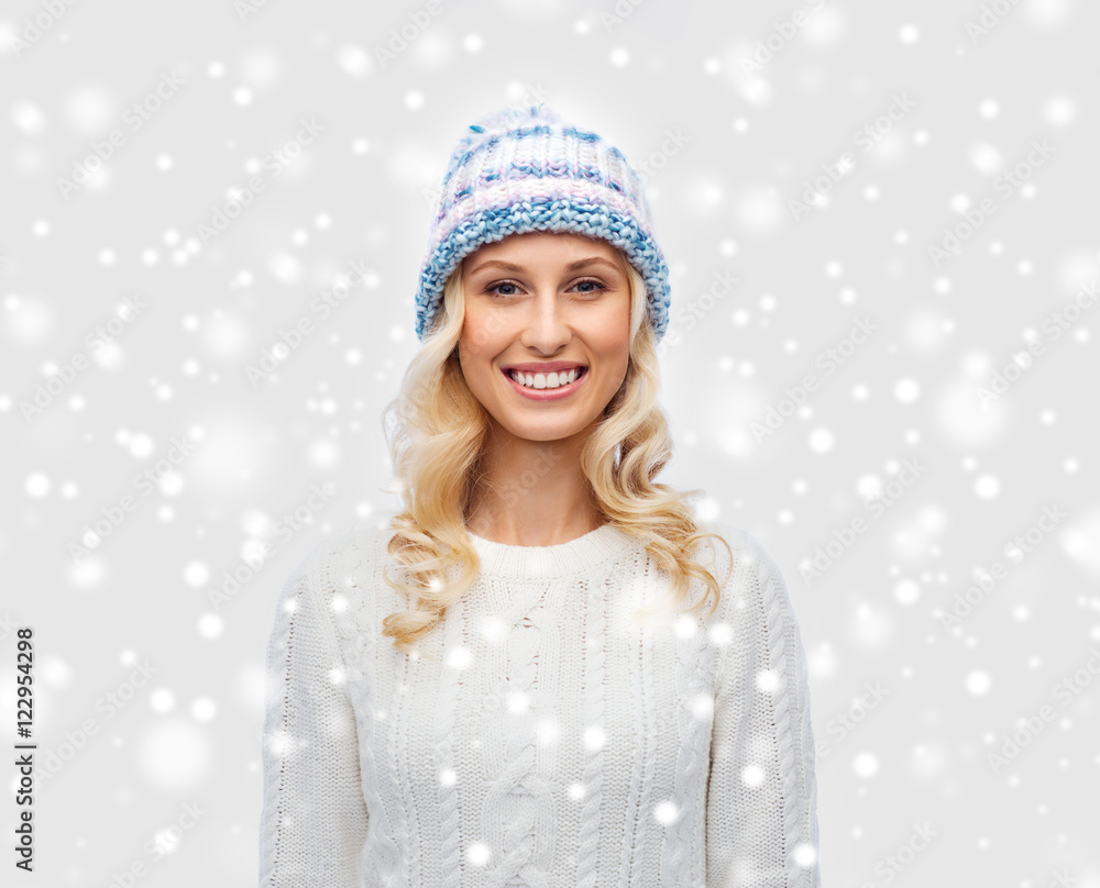 smiling young woman in winter hat and sweater smiling young woman in winter hat and sweater
