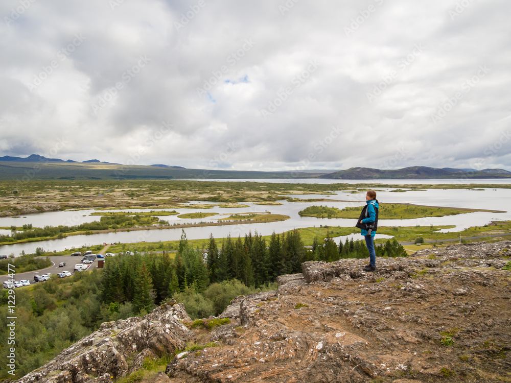 Obraz premium Woman is standing at a cliff in front of the Thingvellir Nationa