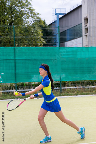 Young attractive female tennis player wearing a sportswear playi © kolotype