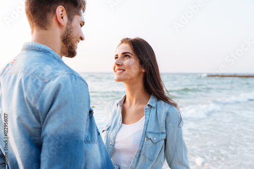 Couple in love looking at each other on the beach