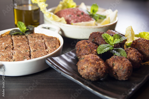 Kibbeh Lbanese food made of finely ground paste of bulgur, onions, and lamb or beef spices and peppermint leaves. Raw, deep fried or grilled. Traditional food of Middle Eastern countrie