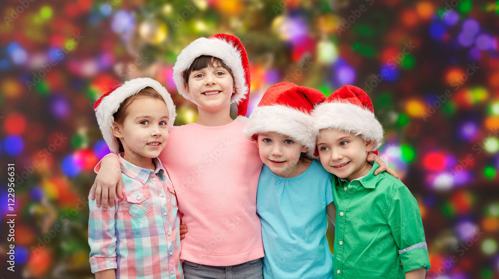 happy little children in santa hats hugging happy little children in santa hats hugging
