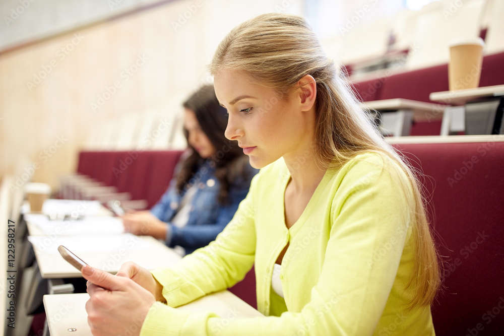 student girls with smartphones on lecture student girls with smartphones on lecture