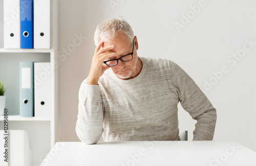 senior man sitting at table