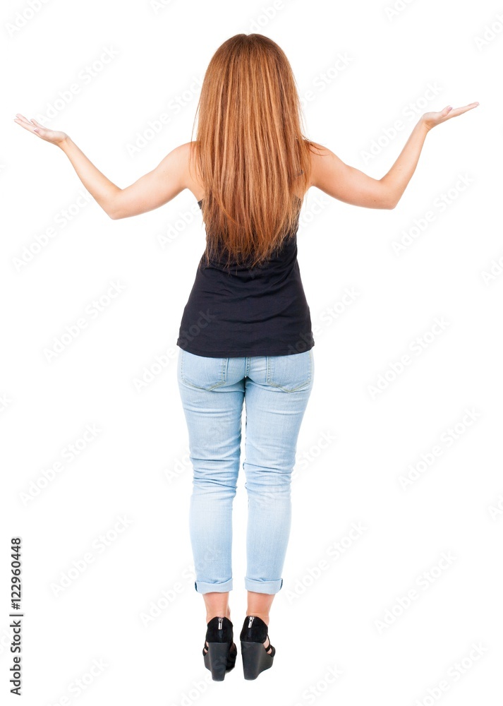 back view of surprised beautiful redhead young woman with hands back view of surprised beautiful redhead young woman with hands