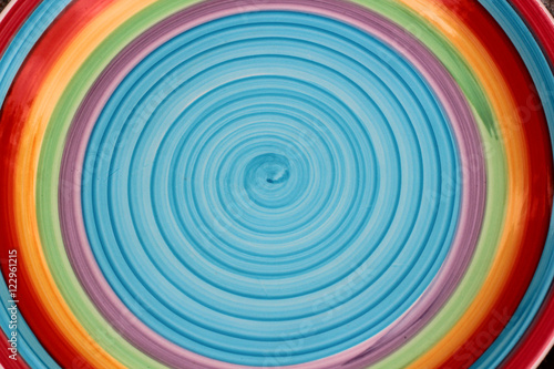 Brightly colored circular background (blue, yellow, red)