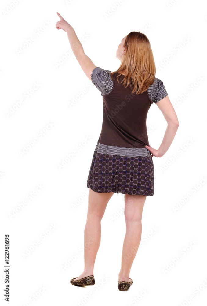 Beautiful young woman looking at wall. Rear view. Isolated over white. Beautiful young woman looking at wall. Rear view. Isolated over white.