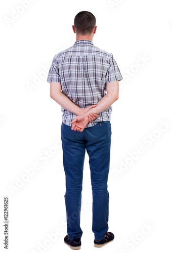 Back view of handsome man in shirt. Standing young guy in jeans. Rear view people collection. backside view of person. Isolated over white background.