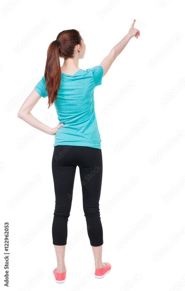 Back view of pointing woman in sportswear. beautiful girl. Rear view people collection. backside view of person. Isolated over white background. Athlete showing his hand up Back view of pointing woman in sportswear. beautiful girl. Rear view people collection. backside view of person. Isolated over white background. Athlete showing his hand up