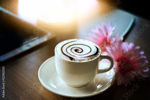 working with tablet and hot coffee cup flowers