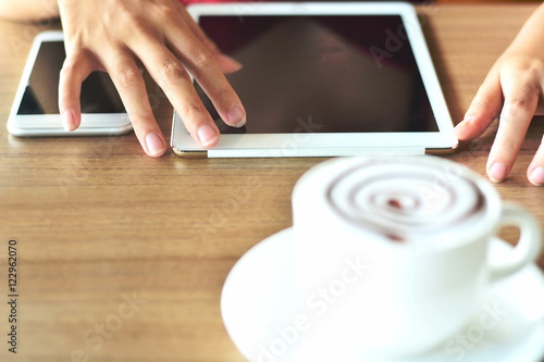 playing  tablet mobile phone and drink hot coffee cup 