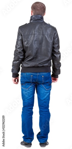 Back view of handsome man in jacket looking Standing young guy in jeans and jacket. Rear view people collection. backside view of person. Isolated over white background.