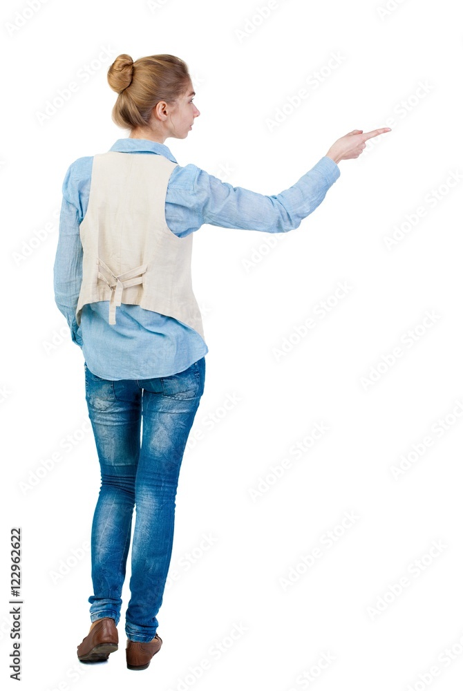 Back view of pointing woman. beautiful girl. Rear view people collection. backside view of person. Isolated over white background. Girl in sleeveless shows a finger to the left. Back view of pointing woman. beautiful girl. Rear view people collection. backside view of person. Isolated over white background. Girl in sleeveless shows a finger to the left.