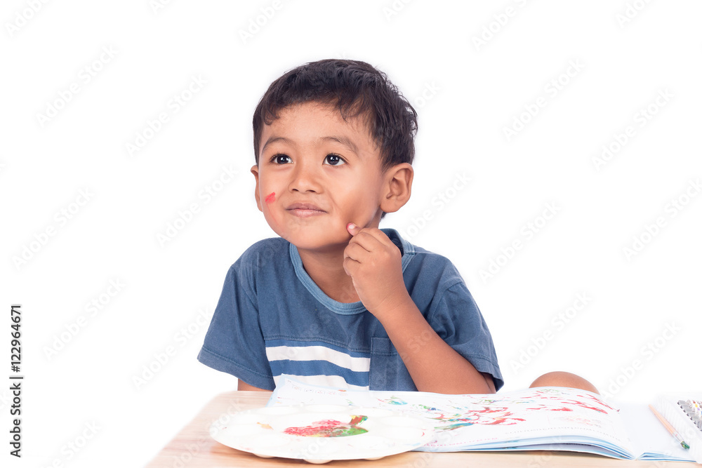 Cute childe asian little boy smile and thinking while doing home Cute childe asian little boy smile and thinking while doing home