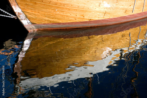 Reflection of a golden ship on the water photo