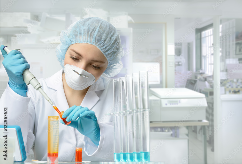 Young energetic female tech or scientist works in laboratory Young energetic female tech or scientist works in laboratory