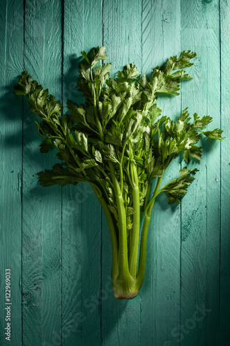 Whole Celery with Leaves on Aquamarine Wood