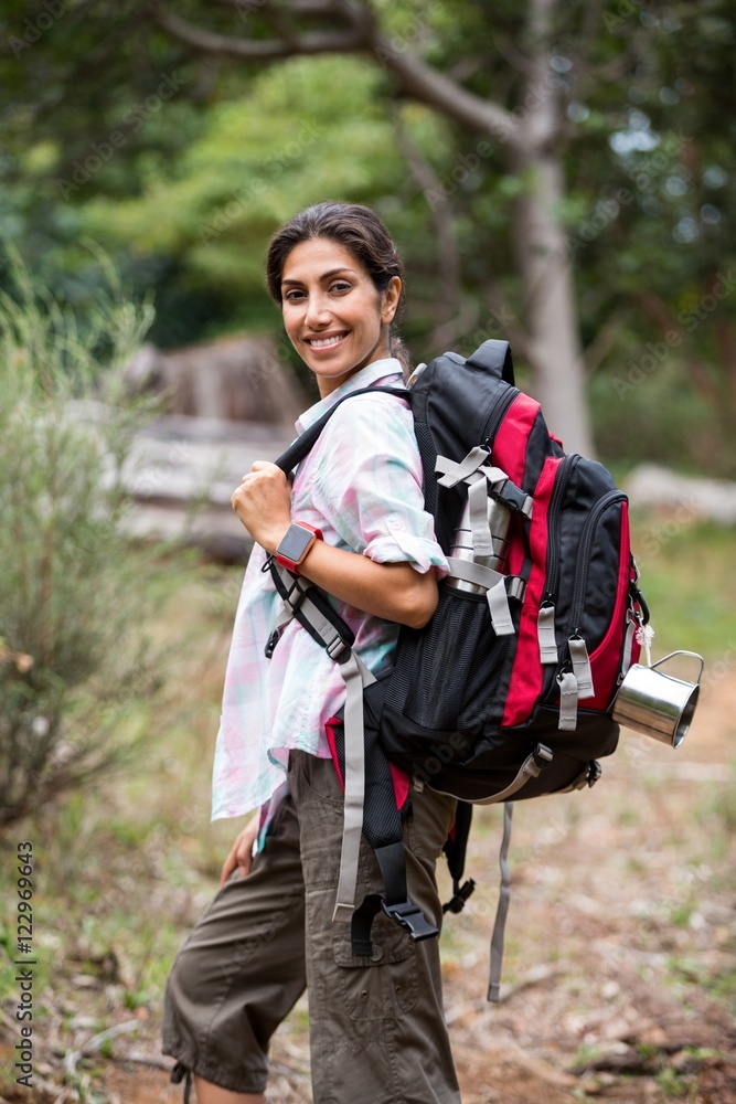 Female hiker standing in forest