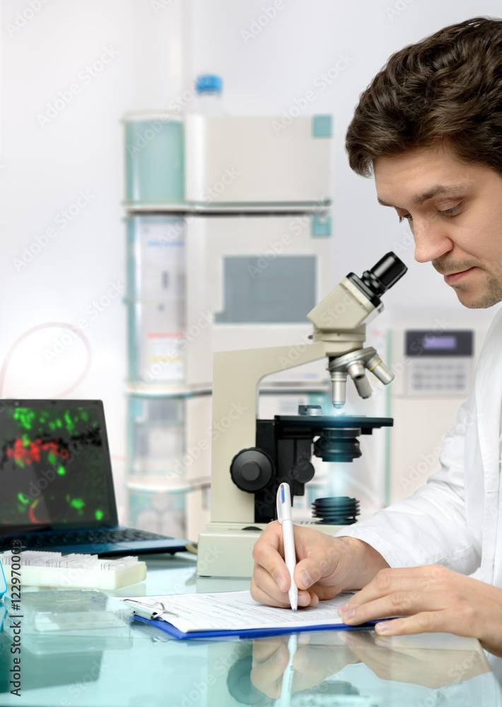 Young energetic male tech or scientist works in research facilit Young energetic male tech or scientist works in research facilit