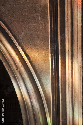 Detail from a Gothic arch lit through stained glass windows, Santa Maria de la Sede Cathedral, Seville, Spain