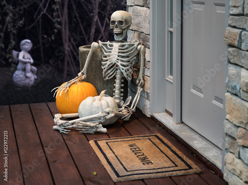 Skeleton and pumpkins in doorway for Halloween