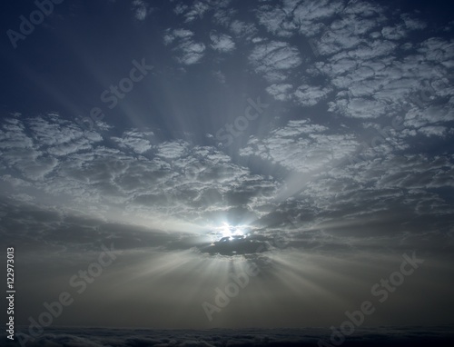 Amazing dawn with sunrays through the clouds
