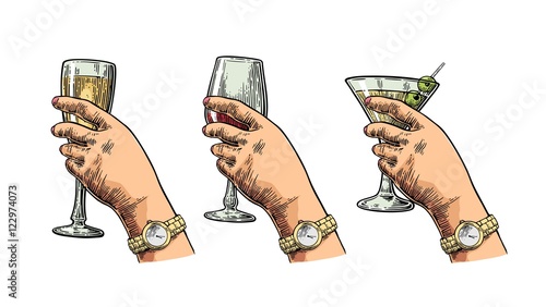 Female hand holding a glass of cocktail, wine, champagne.