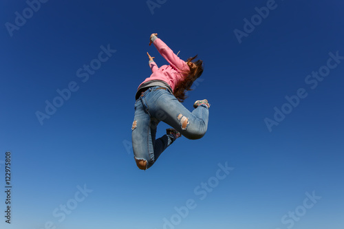 Young beautiful woman dancer jumping