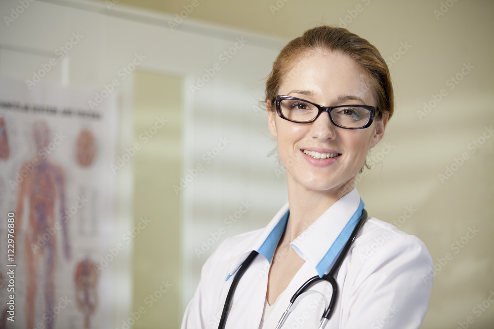 Young confident doctor in classes and white robe with stethoscope smiling at the camera. Doctor office. Young confident doctor in classes and white robe with stethoscope smiling at the camera. Doctor office.