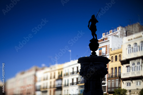 Fountain with a statue of Mercury, San Francisco square, Seville, Spain. Tilted lens used for shallower depth of field. photo