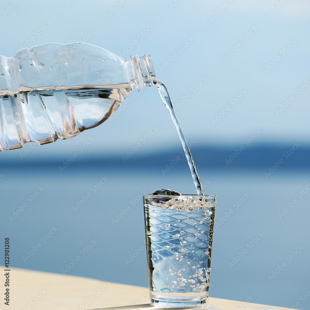 water pouring into glass from bottle Stock Photo Adobe Stock