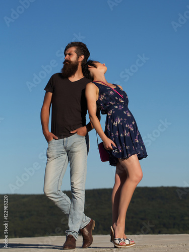 Couple pose on blue sky © Volodymyr
